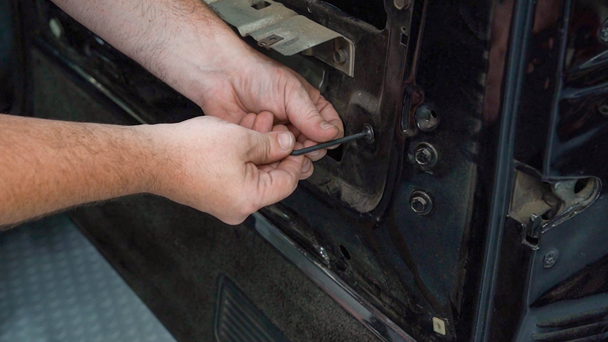 Removing bolt to release interior window channel